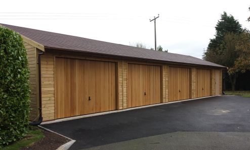 50 x 20 Garage with Cedar infill U&O doors, and a small workshop at the end of the 4 bays.